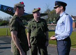 RAF Uxbridge Stn Cdr Gp Capt Paul Hughesdon, discusses plans for the rehearsals with from left, Major Tom Mackay and Master Warrant Officer John Barron of the Canadian Black Watch Regt