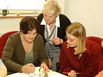 Mrs Eileen Guy (left) and Miss Lorraine Duffield (right) get some advice from Mrs Jackie Pickup (centre) on the finer points of pottery painting at an introductory class, part of the Learning at Work Day held today (14 May 2002) in the Headquarters Personnel and Training Command at Royal Air Force Innsworth