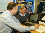 Peter Hopper, TGDA Secretary, tries his hand at an interactive test under the close supervision of Flight Sergeant Carole Bain