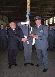 Regional President, Wing Commander John Lewington presents the 'Millennium Sword' award to Wing Commander Ken Davies with the Central & East Yorkshire Banner in the background