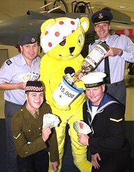 Station Commander Group Captain Julian Young, Sergeant Mark Atkinson who had the original idea for the project, Pudsey Bear, with Leading Airman Photographer Jeff Brown from HMS Gannet and Lance Corporal Davie Cuthbertson from 1st Argyle and Southern Highlanders, who are both currently training at RAF Cosford