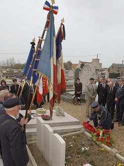 Colours representing French war associations overlooking the grave of Flight Lieutenant Rogers in Ambleteuse cemetery as a wreath is laid by Air Commodore Chris Blencowe MA, BA, RAF on behalf of the Chief of the Air Staff.