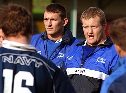Shark attack. FLt Lt Jim Thorp, right, sounds the war cry in the final training session before the Combined Services versus Barbarians rugby match. Flt Lt Howard Parr, centre, is deep in thought.