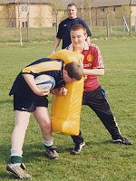 Rugby instruction under the watchful eye of a professional