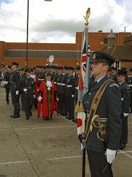 RAF Ensign bearer Fg Off Oliver Walker waits patiently for the reviewing party to pass by