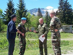 Sqn Ldr Mike Ainsworth (second left) chats to a Russian checkpoint Commander (holding paper), while a French military colleague and interpreter look on